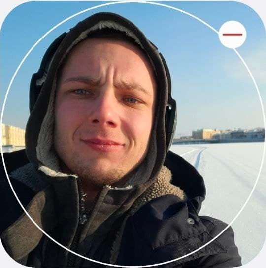 Selfie of Anton Kolhonen in winter clothing by a snow-covered waterfront