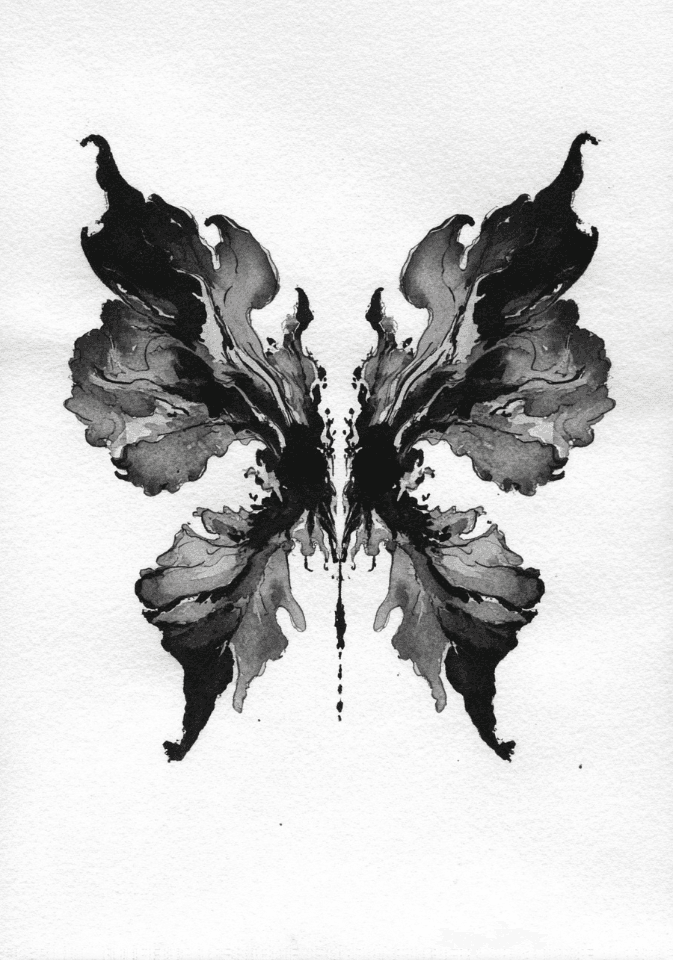 A symmetrical black-and-gray inkblot on white paper.